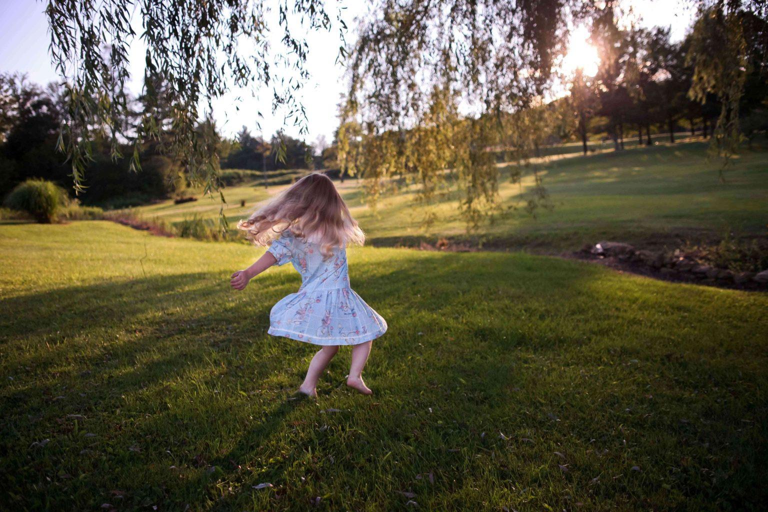 girl-playing-outside-in-summer-dress-playground-for-your-home-teachworkoutlove.com