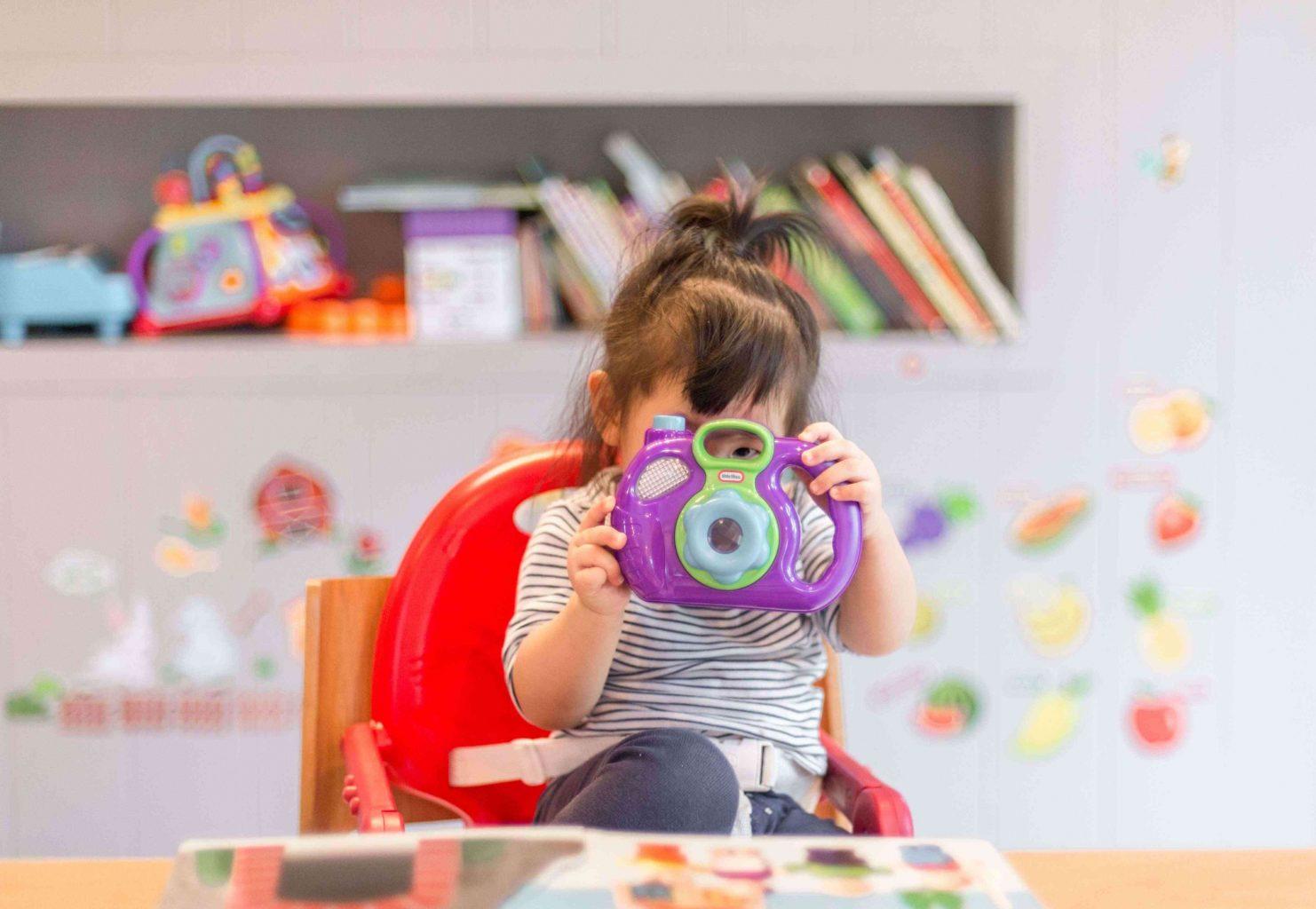 girl-with-toy-book-in-baby's-room