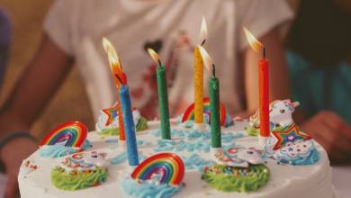 a child holding a birthday cake with candles
