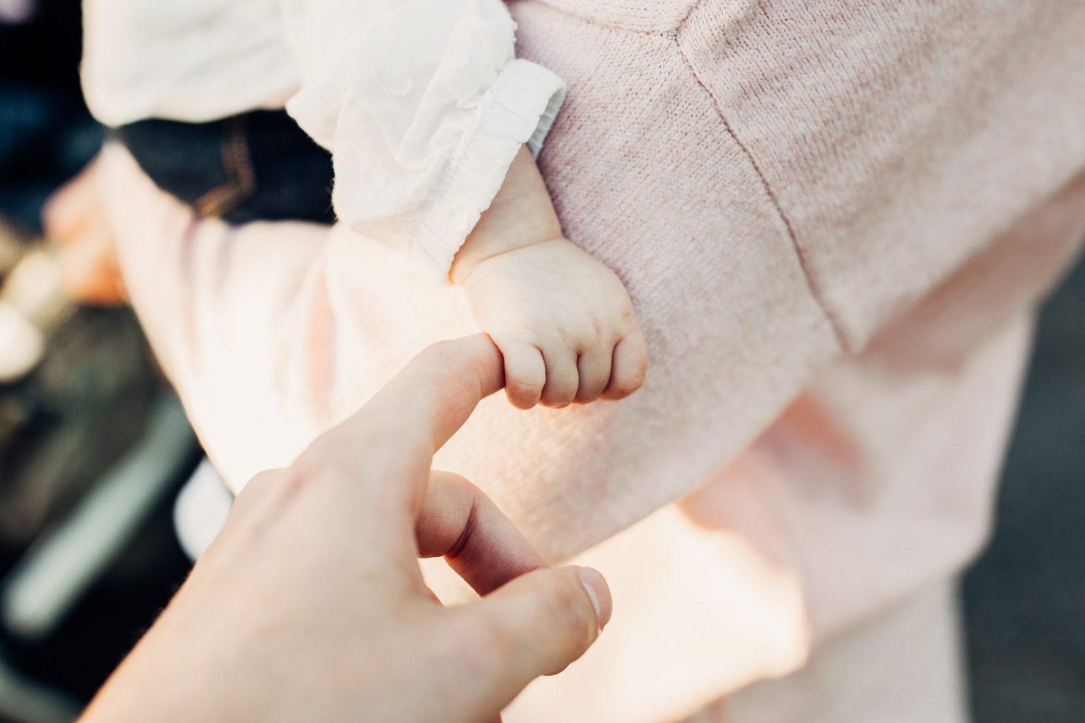 holding baby hand