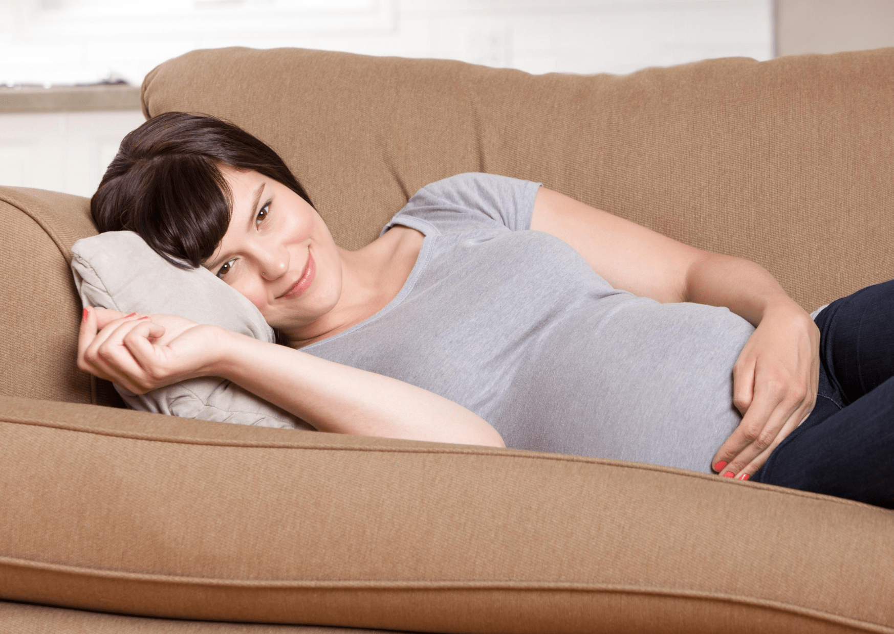 pregnant mom watching netflix on couch
