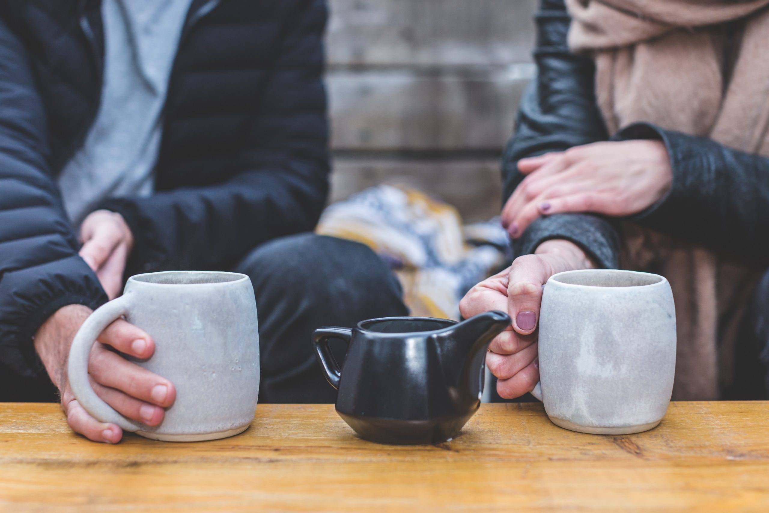 man and woman drinking coffee on date