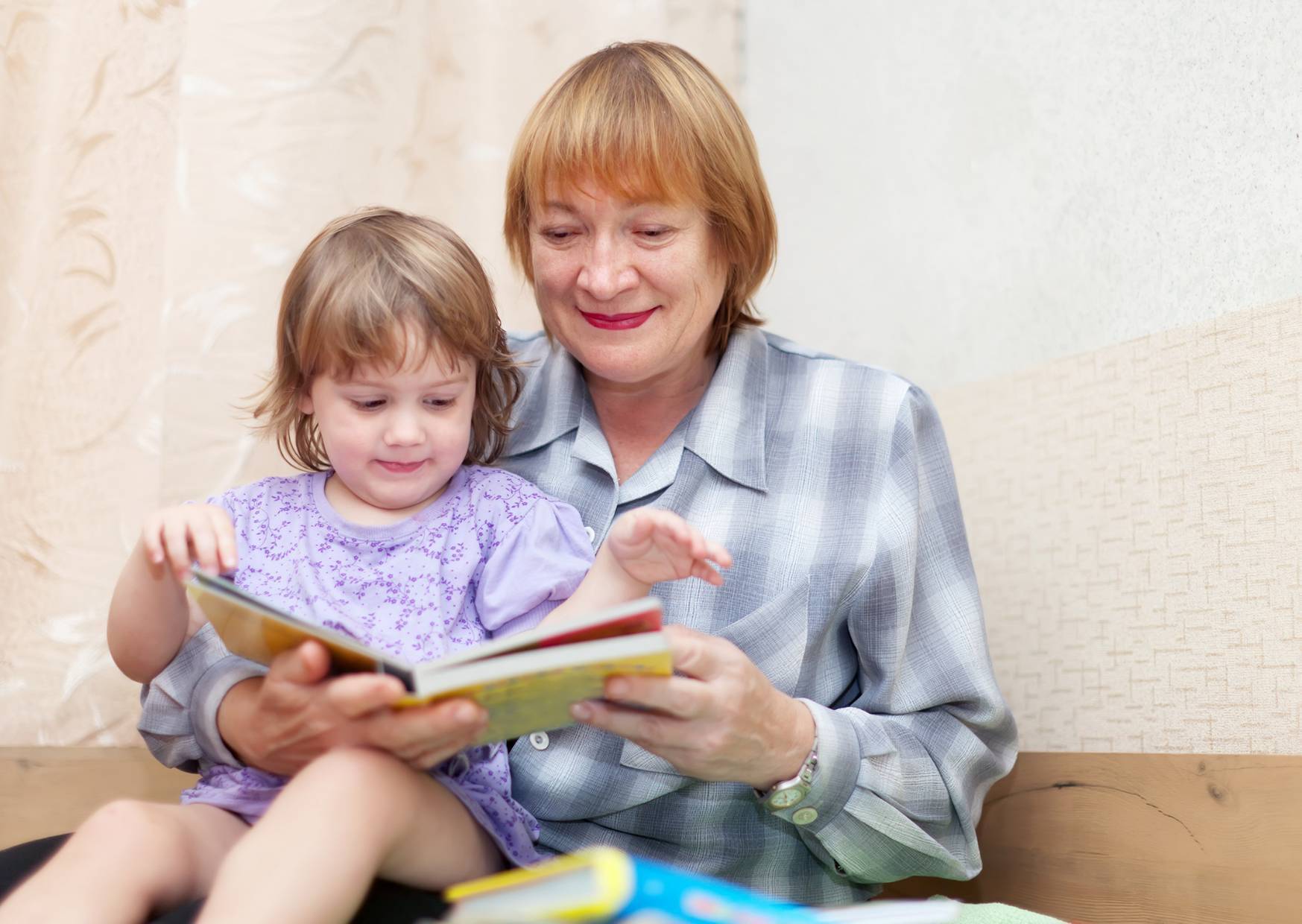 grandma with kid reading a book