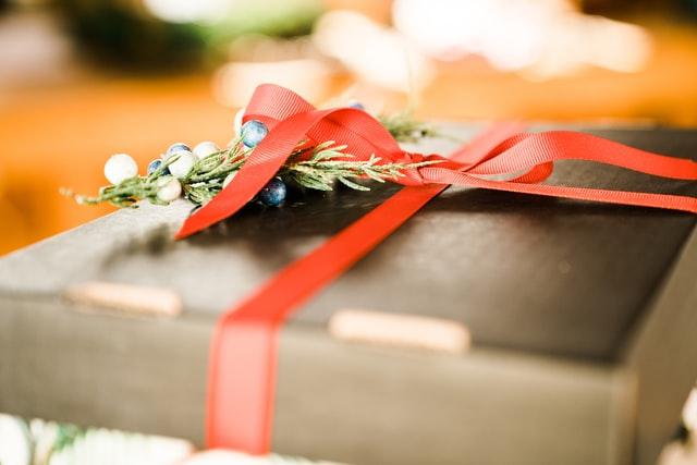 Father's Day, gift box with red ribbon placed on a table