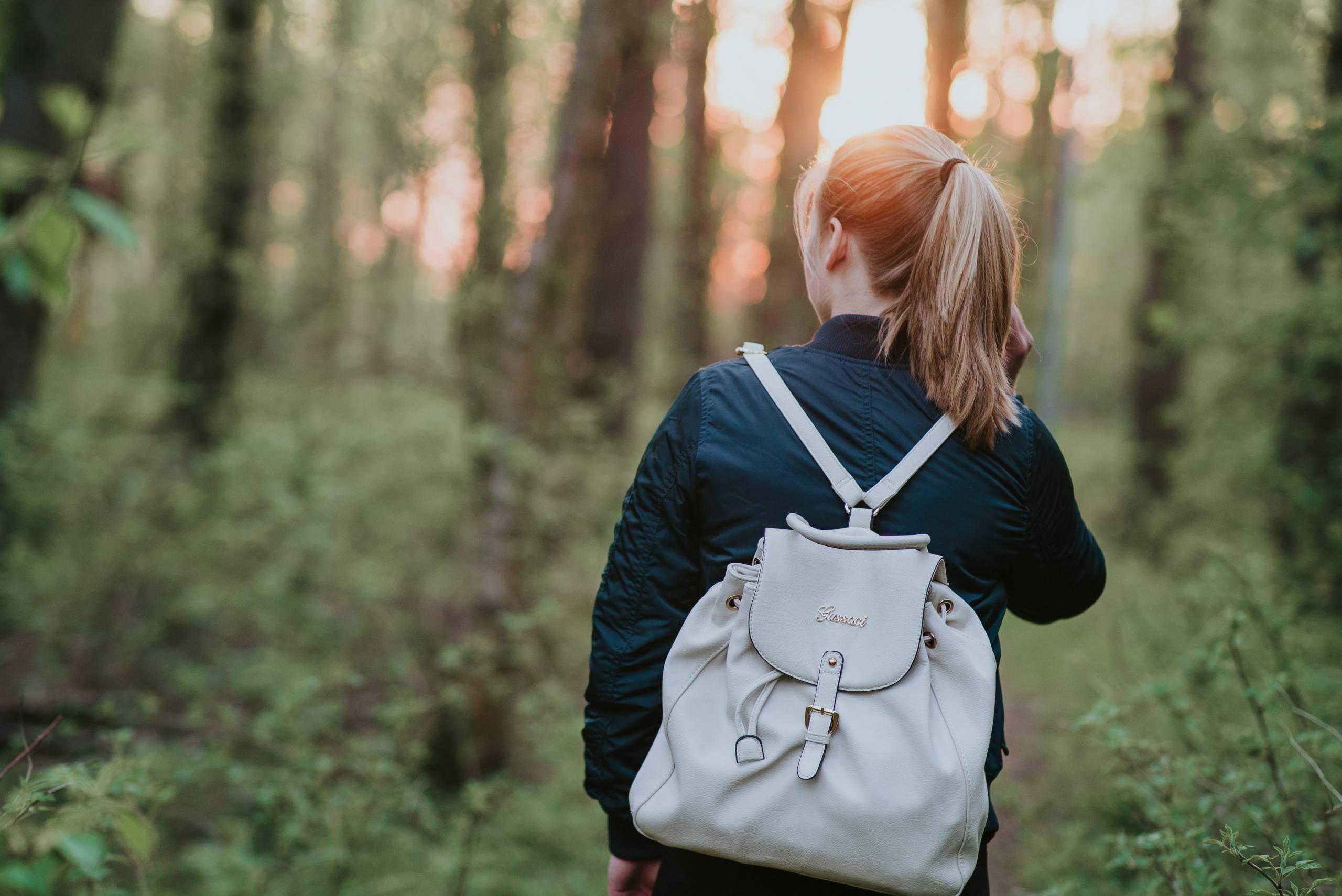 Woman Walking in the wood to boost her mental health in summer