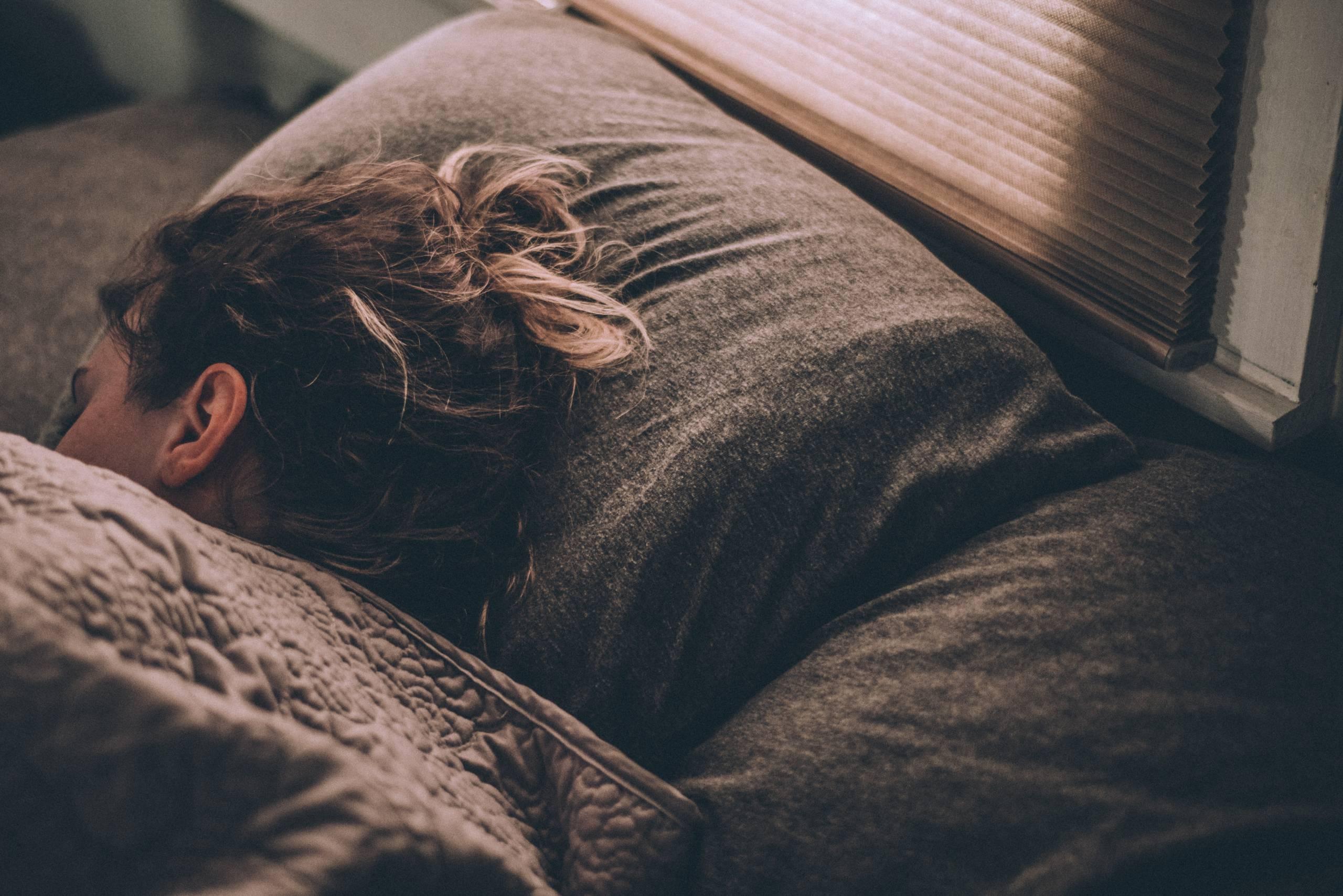 Woman sleeping to boost her mental health in summer